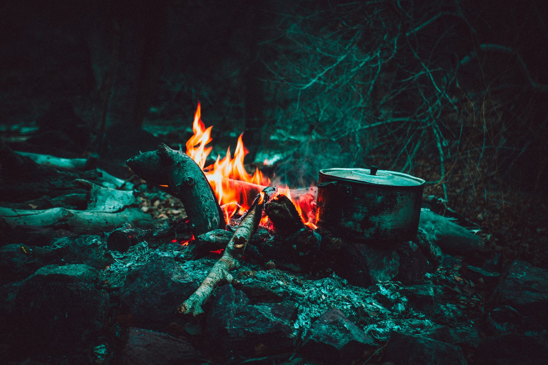 cooking pot near burning wood